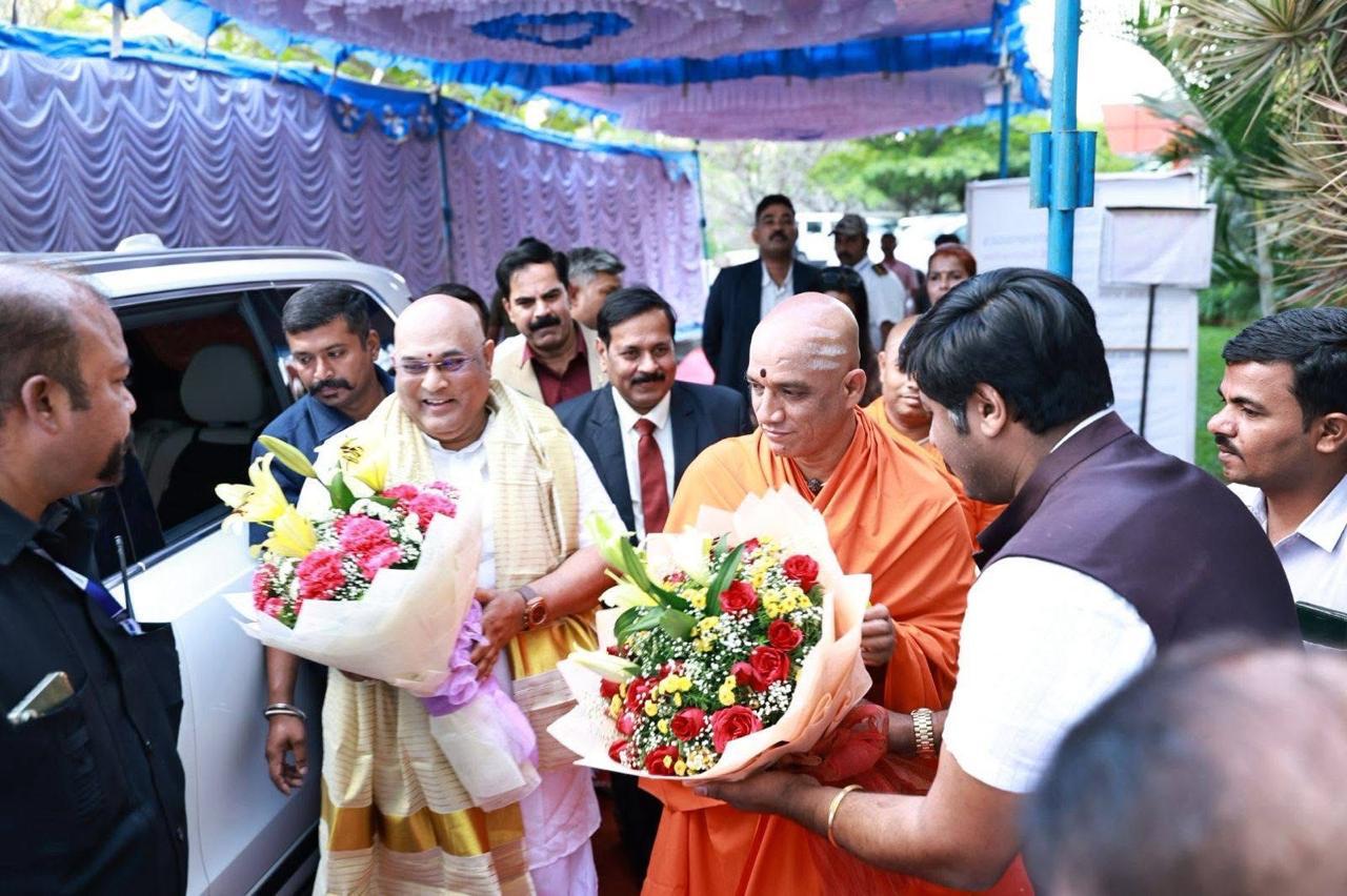 Welcoming the Swamiji and dignitaries with floral bouquets at the event venue