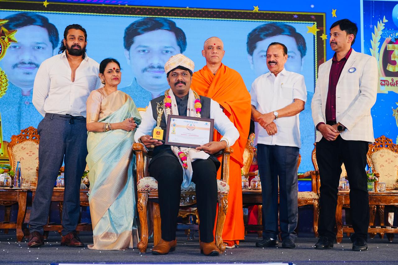 Honoured with a trophy and certificate at an awards ceremony