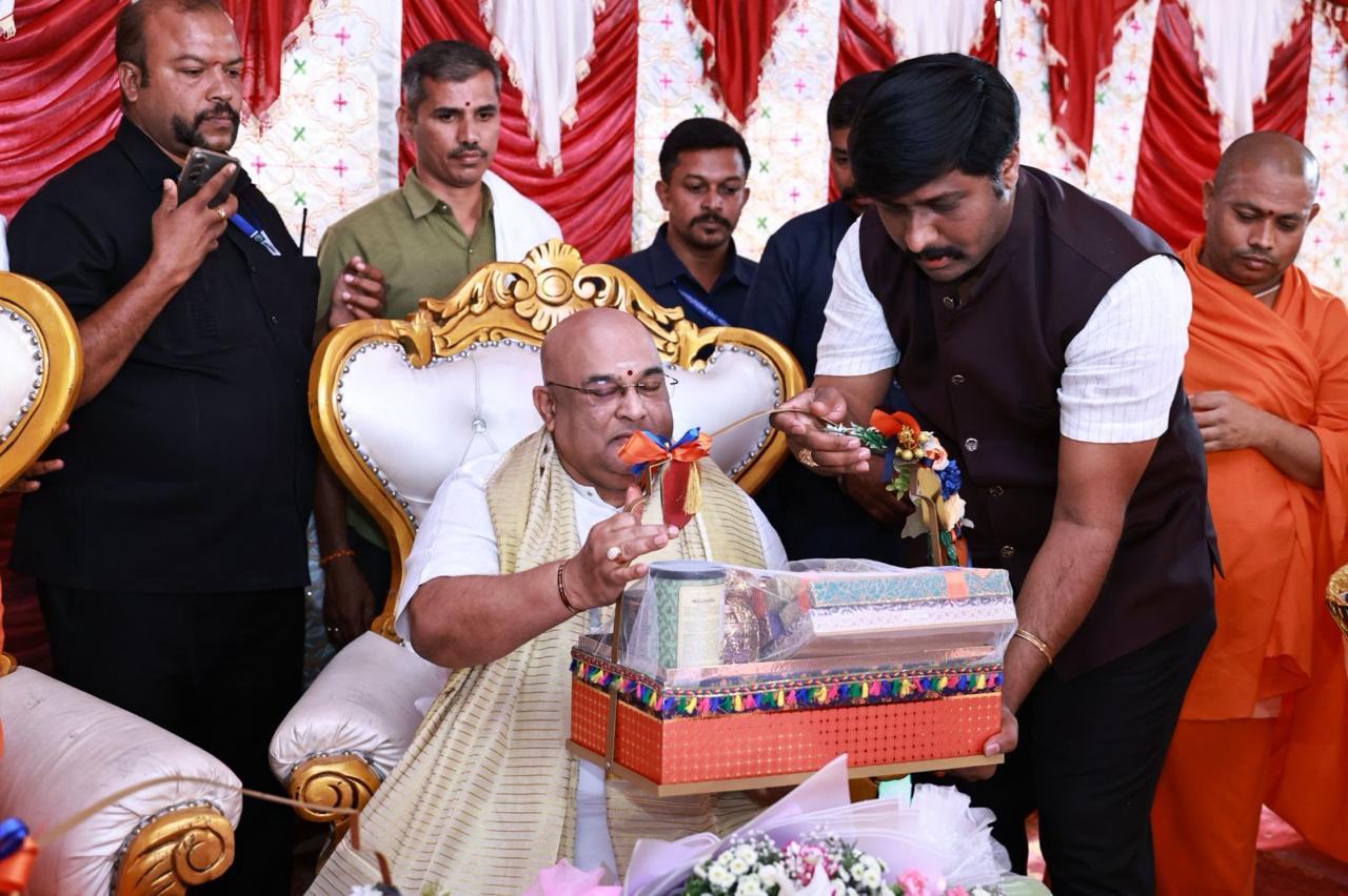 Presenting ceremonial offerings to the seer during the Bhoomi Puja