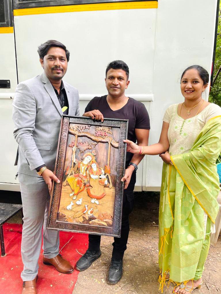 Presenting a handcrafted memento to actor Puneeth Rajkumar