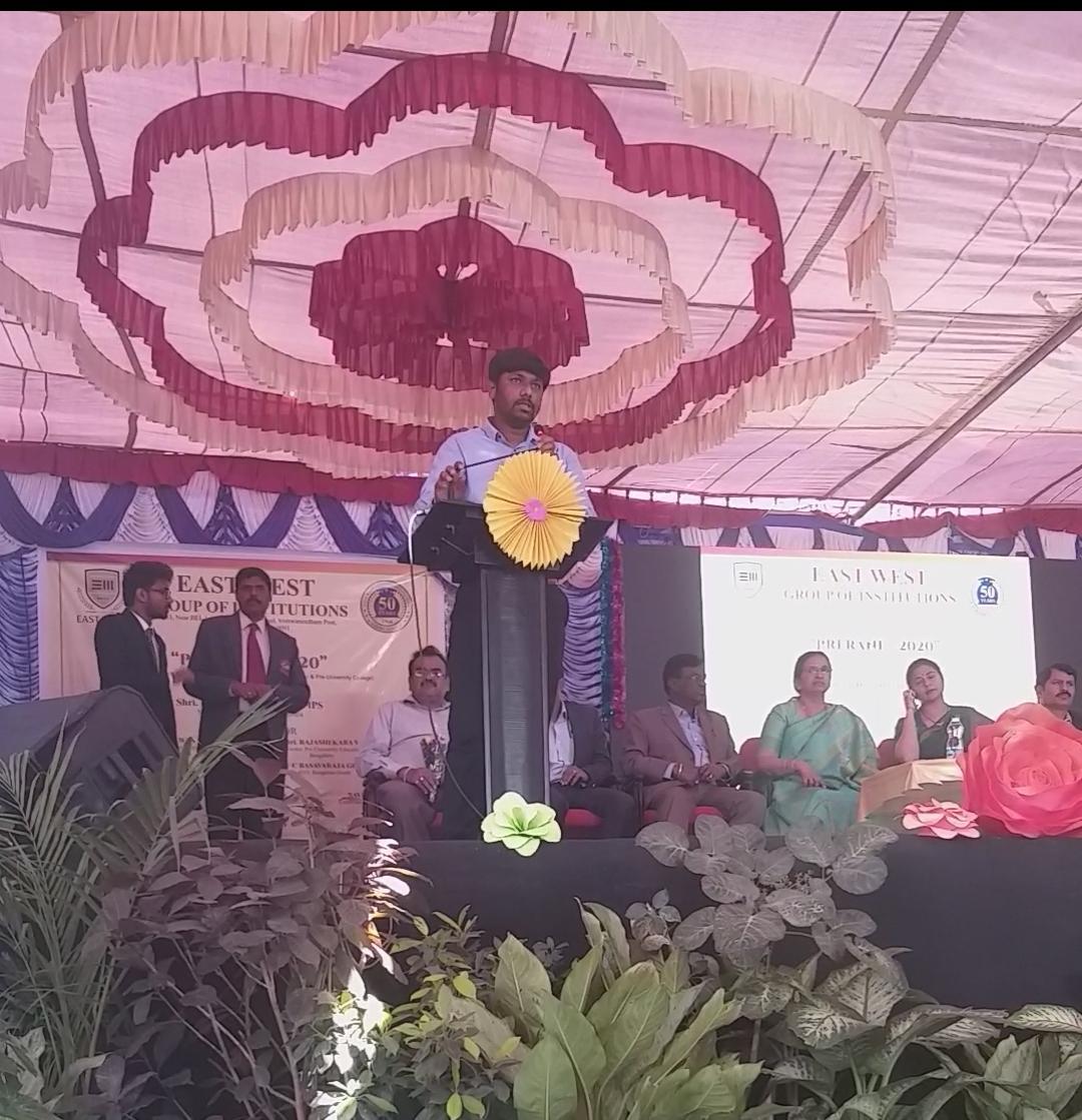Addressing students from the podium at East West Group of Institutions
