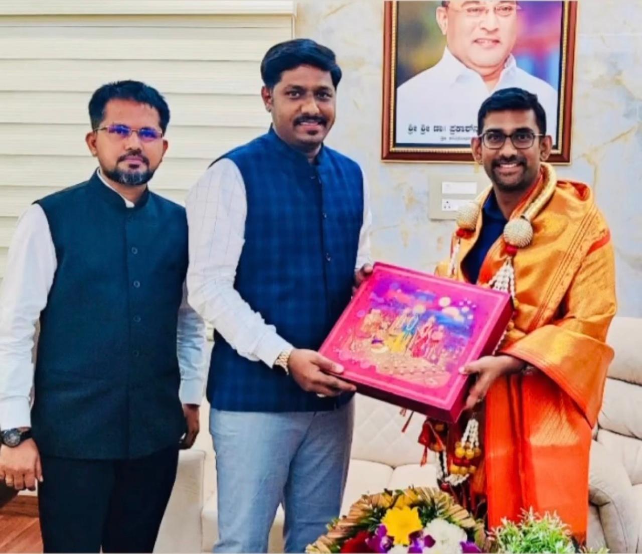Presenting a framed memento to a spiritual leader with a colleague