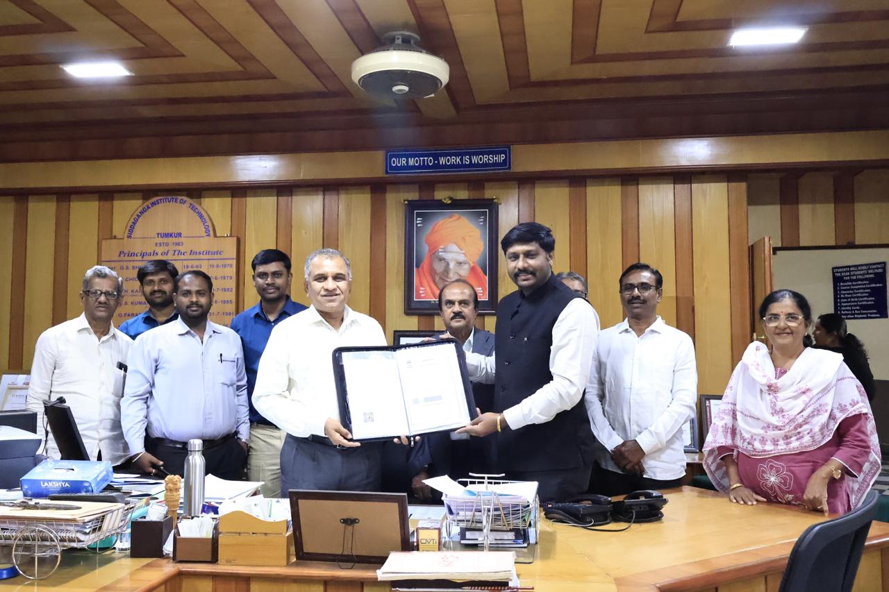 Presenting a signed agreement at Siddaganga Institute of Technology